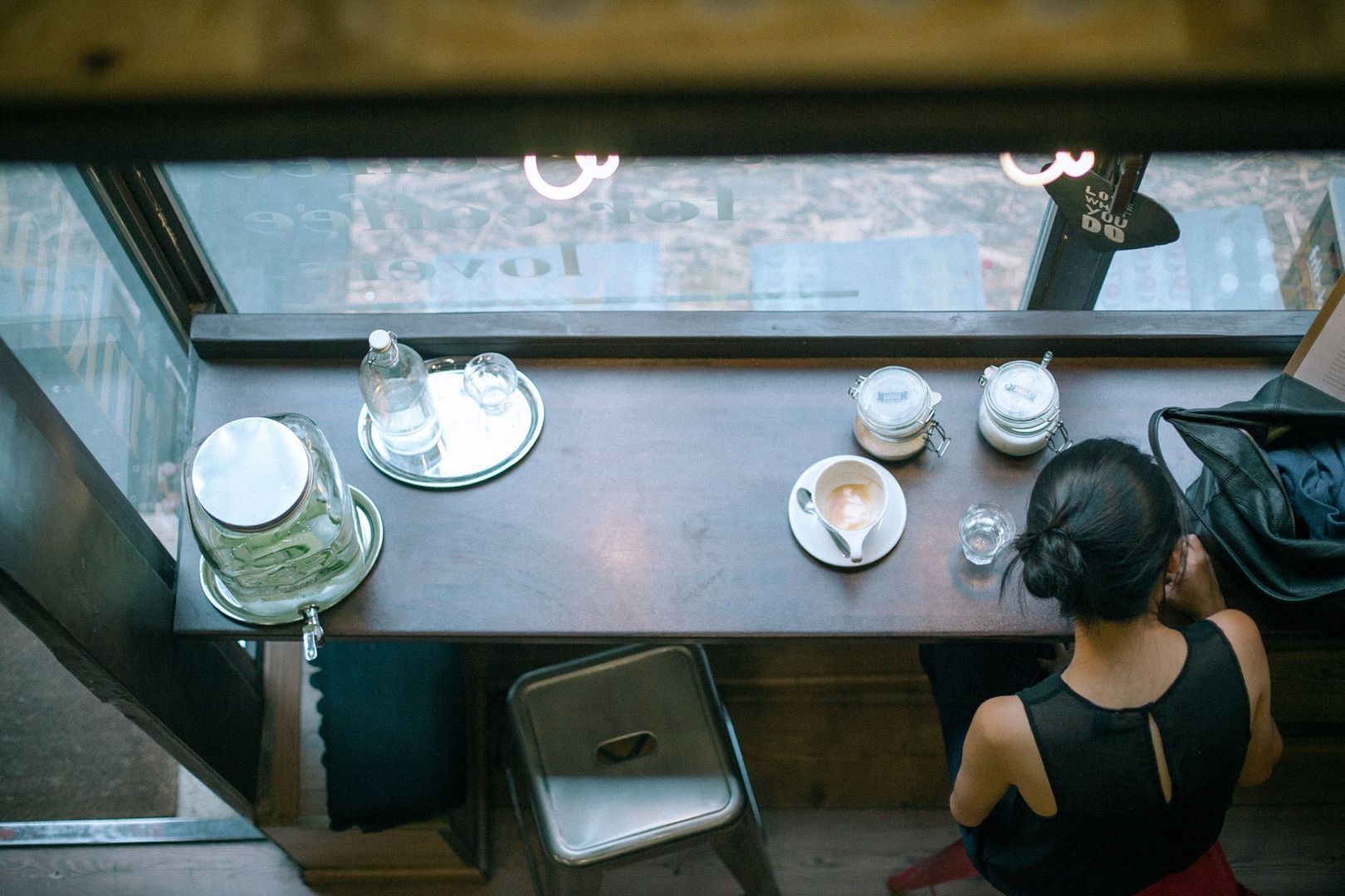 High-angle view of a cozy coffee bar counter with a customer.